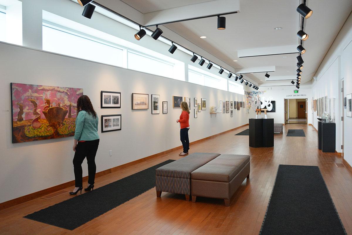 Guests viewing artwork on display in the Sally Otto Art Gallery